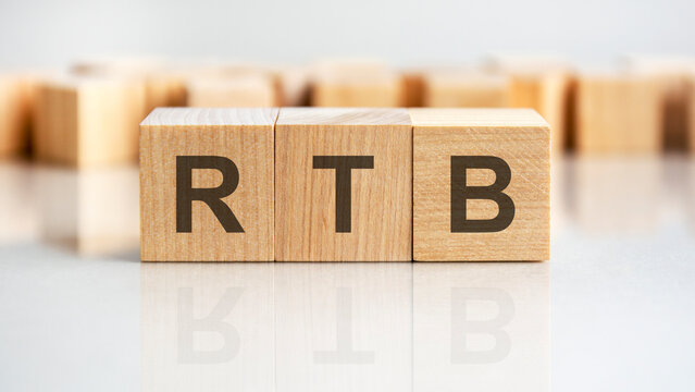 RTB - letters on wooden cubes. business as usual concept image. front view