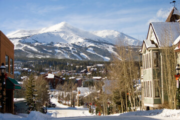 Looking down a street in the ski town of Breckenridge Colorado in winter with Peak 8 in the...