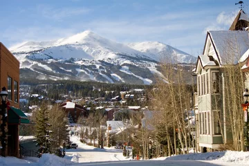 Foto op Canvas Looking down a street in the ski town of Breckenridge Colorado in winter with Peak 8 in the background in Summit County © Jon Camrud