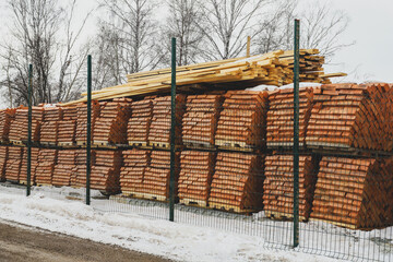 Pallets of bricks for construction. Outdoor storage in winter. Warehousing of large quantities of bricks