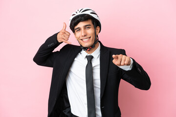 Argentinian businessman with bike helmen isoleted on pink background