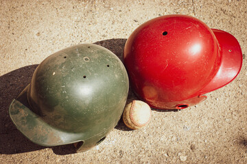 Baseball and batting helmet on ball field