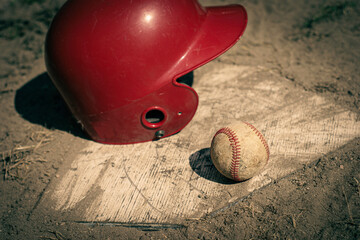 Baseball and batting helmet on ball field