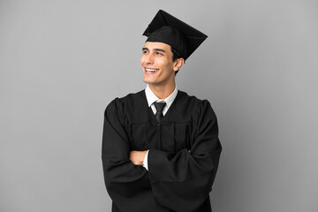Young Argentinian university graduate isolated on grey background happy and smiling
