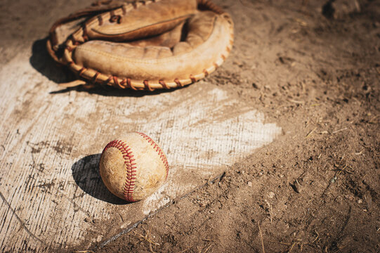 Old Worn Baseball Glove Catchers Mitt On Home Plate