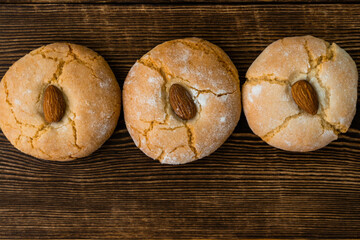 Gluten free italian cookies. Almond cookies and a almond. Sicilian traditional almond biscuits. Biscotti di mandorla siciliani. top view. Copy space