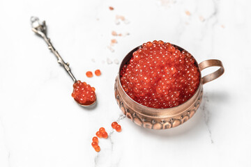 red fish salmon caviar in a spoon on light background macro, luxury delicacy seafood. selective focus, place for text