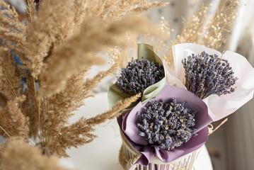 Lavender bouquets in a vase with dried flowers