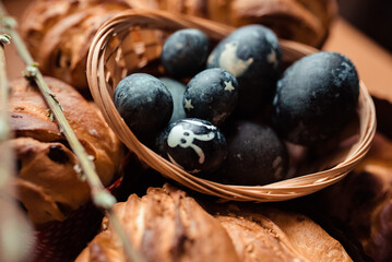 Easter pastries and eggs in blue in a basket