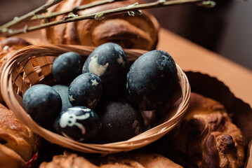 Easter pastries and eggs in blue in a basket