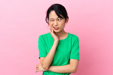 Young Vietnamese woman isolated on pink background with toothache