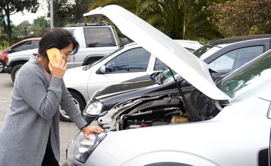 woman calling on her cell phone about her stranded car