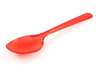 Disposable red plastic spoon isolated on white background. Close-up. Full depth of field.