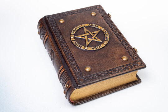 The brown leather book with gilded pentagram and names of the Five elements in Latin