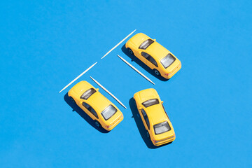 Creative car and transportation idea with yellow cars on vivid blue background. Graphic traffic and parking idea, minimal visual composition.