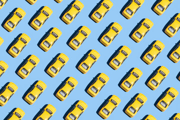 Minimal creative pattern concept with yellow cars on blue background. Aesthetic transportation idea, vivid colors, simple composition.