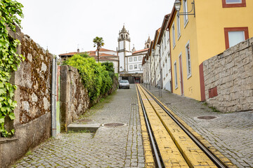 a cobbled street with tram tracks (Calçada Viriato) with a view to Misericordia Church in Viseu, province of Beira Alta, Portugal - obrazy, fototapety, plakaty