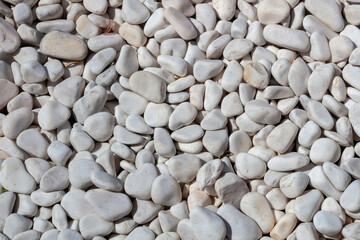 Background of white and light grey stones on a beach