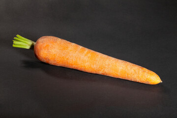 one carrot on black background