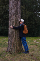 Contact with nature - a woman hugging a tree