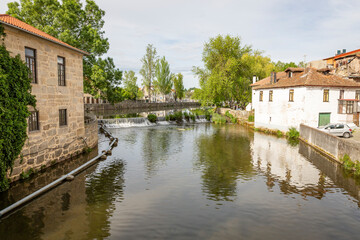 Fototapeta na wymiar Casa da Ribeira and a small weir in Pavia river at Viseu city, province of Beira Alta, Portugal