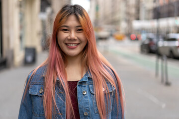 Fototapeta premium Young Asian woman with pink hair smile happy face portrait