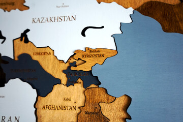 Asian continent on a wooden world map on a wall. Kazahstan, Iran, Afganistan, Kyrgyzstan, ...