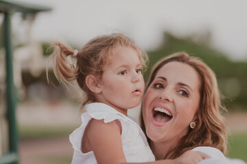 An elderly woman in casual clothes with his daughter spends time together in the park on vacation. Family time. Selective focus