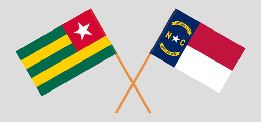 Crossed flags of Togo and The State of North Carolina. Official colors. Correct proportion