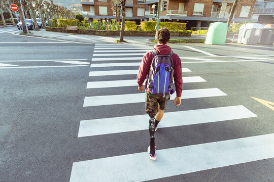 Athlete man, seen from above, on a zebra crossing with an artificial leg