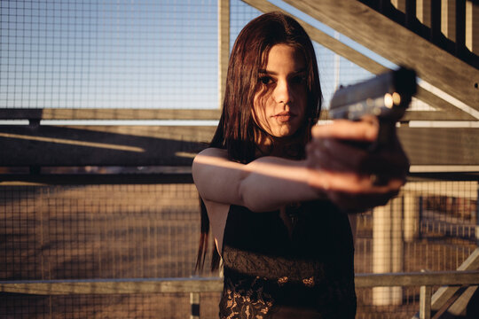 beautiful woman with guns in her hands