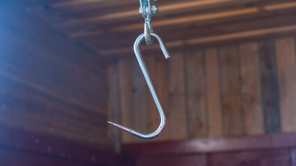 A hook for cutting animal carcasses in a village barn. Butchered and processed hunting trophy...