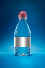 Water Bottle on a blue fresh background. A white label a red color cup so you can change it to whatever you need. 