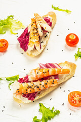 Open sandwiches with boiled shrimps, cream cheese, salad leaves, and cherry tomatoes