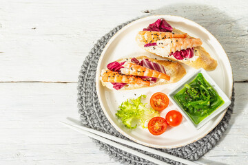 Open sandwiches with boiled shrimps, cream cheese, salad leaves, and Chuka salad. Seafood