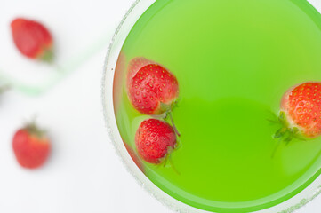 Colorful bright green cocktail cactus with strawberries, delicious refreshing