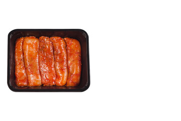 Raw marinated meat.Chicken fillet in tray for supermarket and for baking in oven on white isolated background. raw chicken meat in plastic tray isolated on white background