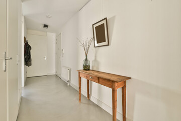 The interior of a narrow corridor i the apartment, in a minimalist style with a cozy design.