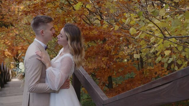 Close up of newlyweds. Lovely young caucasian bride and groom huggin and kiss lovingly. Happy wedding couple.