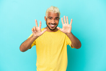 Young Colombian handsome man isolated on blue background counting eight with fingers