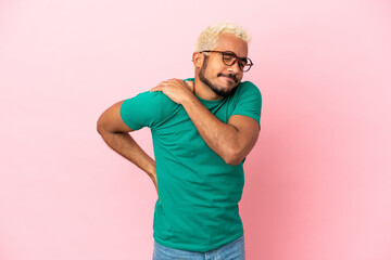 Naklejka premium Young Colombian handsome man isolated on pink background suffering from pain in shoulder for having made an effort