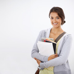 Fototapeta premium So happy at college. Cropped studio shot of a college student smiling widely with books in her arms.