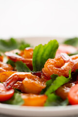Close-up of fresh shrimp, tomato, arugula and greens salad, vertical image with copy space