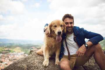 The view is great from up here. Cropped portrait of a handsome young man and his dog taking a break during a hike in the mountains. - Powered by Adobe