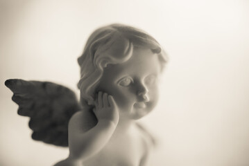 Angelic cupid god of love statue white background. Valentine day or wedding, marry and love concept	