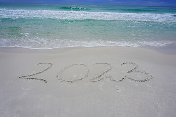 2023 inscription on the sand