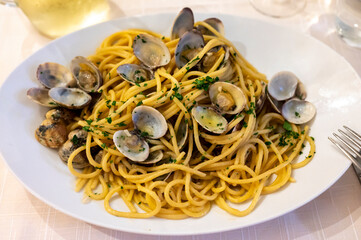 Italian sea food dinner first course pasta with clams alle vongole