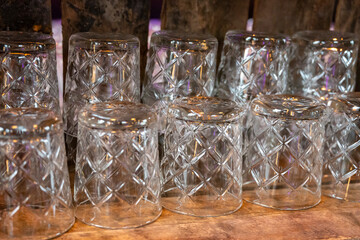 Many clean crystal glasses for water and drinks close up