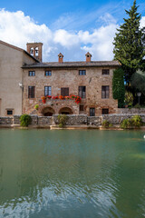 Obraz premium Ancient natural hot springs pool in small Italian village Bagno Vignoni in Tuscany