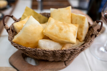 Food of Emilia Romagna region, deep fried bread gnocco fritto or crescentina served in restaurant in Parma, Italy